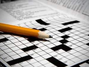 pencil resting on crossword puzzle